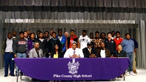 Messenger Photo/Scottie Brown Pike County players Stevie Smiley and Isaac Nickson sign their letters of intent with teammates behind them.