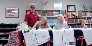 PLAS Lady Patriots sofball catcher Amberlyn Baker signed with Wallace College in Dothan Wednesday in PLAS' Library. Baker was joined by teammates from both the volleyball and softball teams.  MESSENGER PHOTO/SCOTTIE BROWN