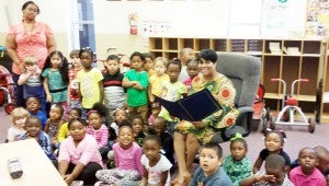 Shelia Jackson, Troy public relations director, reads to the students.