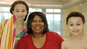 Messenger Photo/Ngoc Vo Armestine Graham with her grandchildren Nora Mullins, 11, and Christian Mullins, 8, at the Troy Parks and Recreation pool. Graham found her calling to take care of people in her family as well as others in need. 
