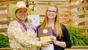 Joy Brigham with the American Cancer Society, left, presents Morgan Grissett a plaque to recognize her as the 2015 Relay for Life Honorary Chairperson. MESSENGER PHOTO/COURTNEY PATTERSON