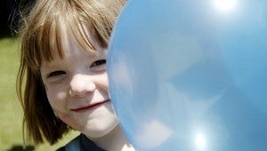 Payton Johnson peeks behind a balloon, providing the signature photo for Kindergarten Fun Day in Brundidge Friday.