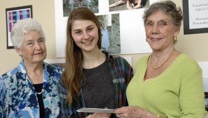 Lizzie Orlofsky is the recipient of the 2015 Troy Arts Council Scholarship. The scholarship award was presented to the Charles Henderson High School senior Tuesday by Ruth Walker, TAC president, left, and Pat Duke, TAC scholarship chair. Orlofsky does a lot of manipulation of her photographs, including super-imposing designs on the photographs using print making and graphic design tools.