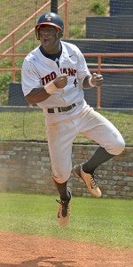 CHHS' Bryson Gandy celebrates after stealing home during the Trojans game against Muscle Shoals on Saturday. The play was part of a seventh-inning rally that tied the game and gave the Trojans the momentum needed to win. MESSENGER PHOTO/THOMAS GRANING