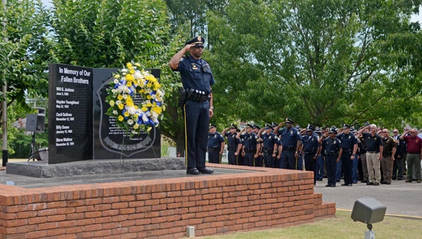 Lt. Greg Wright placed the wreath honoring the five fallen officers from Troy Police Department on top of the Memorial Marker in front of the police department during the 37th Annual Police Memorial Day Ceremony.
