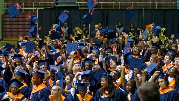 Charles Henderson High School graduates toss their caps at the end of graduation. (Photo/Thomas Graning)