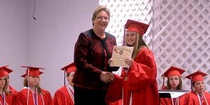 Messenger photo/scottie Brown Morgan Bundy shakes Pike Liberal Arts headmaster Becky Baggett’s hand while receiving her certificate of graduation during the school’s sixth grade graduation Thursday. 