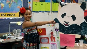 Messenger photo/Scottie Brown For their end of the year project, Goshen Elementary second graders had the opportunity to learn fun facts about different countries, even dressing up in their countries traditional costumes. Students made posters about their countries and detailed different facts about them such as population, the country’s leader and how many miles from Alabama the country was. Because it was an international project students also made passports with the different countries getting their respective squares. Students signed their names to the countries they studied and set themselves up for an afternoon of world traveling tasting different cuisines and learning interesting facts about the countries they and their peers studied.