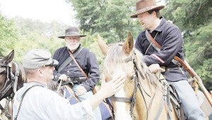 Bob McLendon, left, commanded the Union cavalry at the “Ambush at Hobdy’s Bridge re-enactment. Local re-enactors, McLendon and Joe Murphy, talked with Johnny Reb following the re-enactment. The young Reb wanted to know how two Southern gentlemen could ride against the Confederates. Murphy said, in re-enactments “somebody’s just got to do it.”