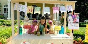 Submitted photo Campbell, left, Mary-Jane Campbell, middle, and Sarah Gray, right, stand together after Mary-Jane got a cup of lemonade. Sarah Gray and Campbell raised more than $550 Saturday to support NeverThirst selling lemonade, tea cakes and cookies to raise money for clean water efforts. 
