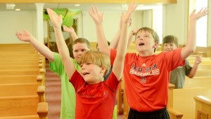 MESSENGER PHOTO/QUINTA GOINES Southside Baptist church is hosting its “Journey off the Map” themed VBS this week. Over 100 children signed up to be a part of the journey. Andrew Galloway, front; Connor Thrash, back right and Colton Taylor, left back, dance to the theme song during the assembly Tuesday morning.