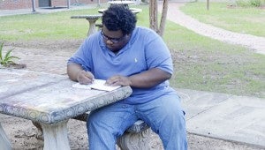 Messenger photo/Quinta Goines Reginald Waller practices his childhood hobby and future career, drawing, at the courtyard of Malone Hall on the Troy Campus Sunday evening.