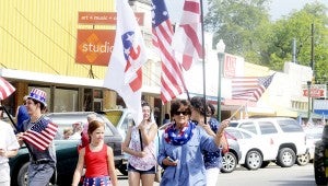 MESSENGER PHOTO/QUINTA GOINES The City of Brundidge hosted its annual Independence Day Parade Saturday morning. The Pike County Republican Women march with the United States flag and Republican flags.