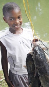 MESSENGER PHOTO/JAINE TREADWELL Kameron Christian caught a big stringer of fish that weighed in at 10 pounds 14 ounces. That was enough weight to earn him the top fisherman in the 5-7 age group. 