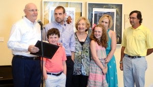 MESSENGER PHOTO/COURTNEY PATTERSON Mack Gibson, far left, accepts a plaque with his family at the Johnson Center for the Arts at Donor Day Sunday.