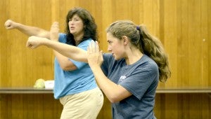 MESSENGER PHOTO/SCOTTIE BROWN Troy Police Department is putting on a R.A.D. three-day self-defense course for women in the First Baptist Activities Building. Sgt. Mike O’Hara said a mother concerned about her daughter leaving for college and being on her own for the first time had spearheaded the efforts for this year’s class. Melanie Hamlin, back, and Taylor Hamlin, front, throw punches during a striking exercise during the second day of the R.A.D. course Tuesday night.