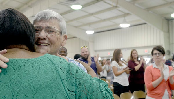 Barbara Holladay hugs Banks Elementary School principal Lee Scott before she walks on stage to accept her pin for 35 years of service in the Pike County School System. Holladay has worked as a bus driver for 35 years and said she has driven the same route during her time as a driver. MESSENGER PHOTO/SCOTTIE BROWN