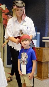 MESSENGER PHOTO/COURTNEY PATTERSON Family Eye Center held its annual Kids Day with a pirate theme. The official name was “Pirates of the We Care Yer See’in” Dr. Mary Kate Moring ties a bandana onto Turner Dixon’s head, helping to complete his pirate outfit for Kids Day. 