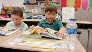 Messenger photo/Scottie Brown Carson King reads his text book on the first day of school Monday in Jessica Moran’s second grade class.