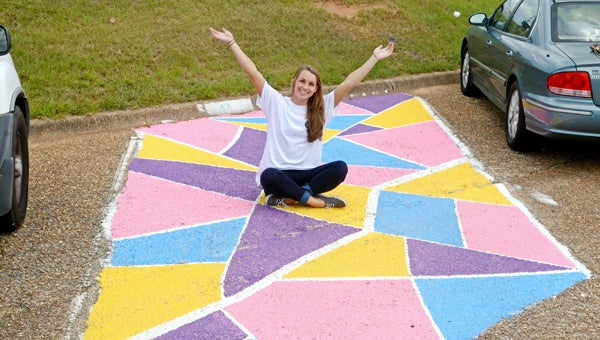 Christina Lecroy shows off her parking spot at Charles Henderson High School. She painted the spot herself to represent her personality. MESSENGER PHOTO/COURTNEY PATTERSON