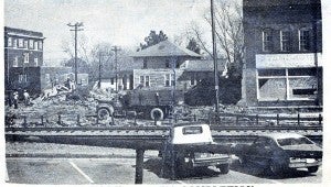 An old news photo shows the damage and the work being done after the Hotel Troy burned down in 1971.