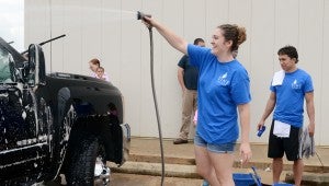 MESSENGER PHOTO/COURTNEY PATTERSON Members of The Vine Church washed cars for free during their annual Serve Day.