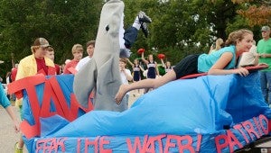 MESSENGER PHOTO/COURTNEY PATTERSON Pike Liberal Arts School held its annual homecoming parade Thursday. A float mimics the movie “Jaws,” showing a football player’s feet sticking out of the mouth and words stating “Fear the Water.”