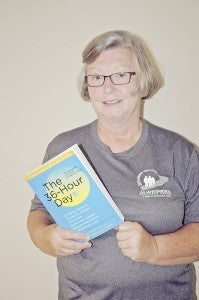 MESSENGER PHOTO/JAINE TREADWELL Ann Marie Hussey holds “The 36-Hour Day.” Hussey introduced the book at the Alzheimer’s Support Group meeting Thursday at Troy Regional Medical Center. The book is a free resource.