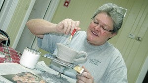 MESSENGER PHOTO/JAINE TREADWELL Melanie Sessions is back making pottery after being in the classroom for 28 years. Sessions is among the potters at the Colley Senior Complex Pottery House.