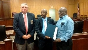 SUBMITTED PHOTO Harry Sanders, Pike County Commission administrator, left, and Commission Chairman Homer Wright, center, present a proclamation with John Reynolds, who was active with SCOPE.
