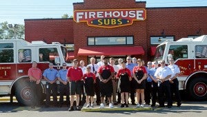 MESSENGER PHOTO/COURTNEY PATTERSON Troy Fire Department, Firehouse Subs employees and representatives and Troy Mayor Jason Reeves gathered at Firehouse Subs Thursday morning as Firehouse Subs presented a grant to Troy FD.