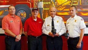 MESSENGER PHOTO/COURTNEY PATTERSON Pictured, from left, are David Conklin, area representative for Firehouse Subs; Rex Lewis, Troy franchisee for Firehouse Subs; Troy Fire Chief Thomas Outlaw and Lt. Paramedic Clay McDougale. 
