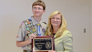 MESSENGER PHOTO/COURTNEY PATTERSON Julian Graham, left, accepts a plaque from Troy Regional Medical Center CEO Teresa Grimes for his Eagle Scout Project.