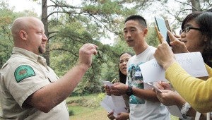 MESSENGER PHOTO/JAINE TREADWELL Troy University students from China participated in a Classroom in the Forest event hosted by John and Carol Dorrill at their Clay Hill Farms near Pronto on Thursday.