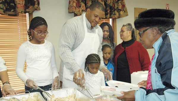 MESSENGER PHOTO/JAINE TREADWELL Former collegiate and professional football player Cornelius Griffin’s dream now is being a husband and father. Griffin and his family host the annual community Thanksgiving dinner in Brundidge, his hometown. Griffin is teaching his children the importance of giving back. Pictured with Griffin, from left, daughters, Mikalah and Hailey, son C.J.; wife, Kimberly; and mother, Martha Griffin.