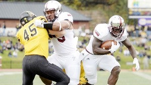 Submitted Photo Trojan running back Brandon Burks runs the football Saturday afternoon against the Appalachian State Mountaineers. Burks and the Trojans fell to the Mountaineers 44-41 in triple overtime. 