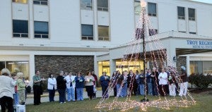 MESSENGER PHOTO/COURTNEY PATTERSON Troy Regional Medical Center invited the community to remembered loved ones during the sixth annual Lights of Love tree lighting ceremony Wednesay. TRMC staff and community members gathered around the tree in front of the hospital as names were read to honor loved ones. Money raised during the event will go toward sponsoring families in the community during the holidays.