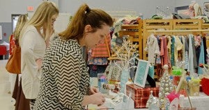 MESSENGER PHOTO/COURTNEY PATTERSON Above, Alison Baggett shops at the Pike Liberal Arts School Patriot Christmas Marketplace Thursday.