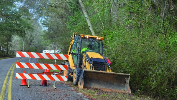  Dwight Wheeler with the PIke County Road Department works to repair another section of the same road.  