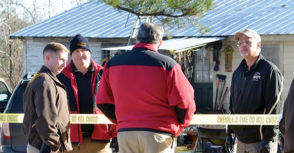 Sheriff Russell Thomas talks with deputies at the scene of the shooting.