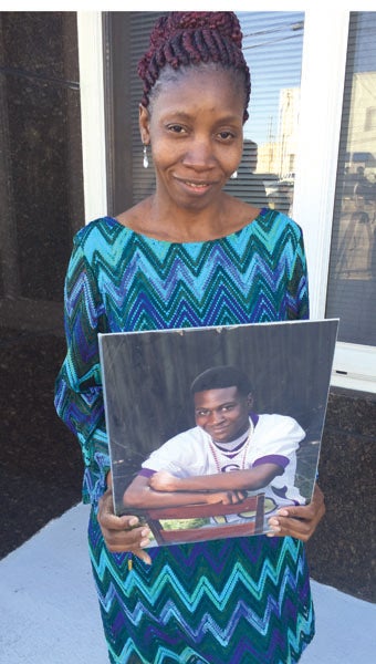 Carolyn Jackson held this photograph of her son, Dre, as she testified during the sentencing hearing for her ex-husband, Sammy Jackson, who was convicted of murdering their son and attempting to murder a second son. Sammy Jackson was sentenced to life in prison as well as a 25-year term for the attempted murder.