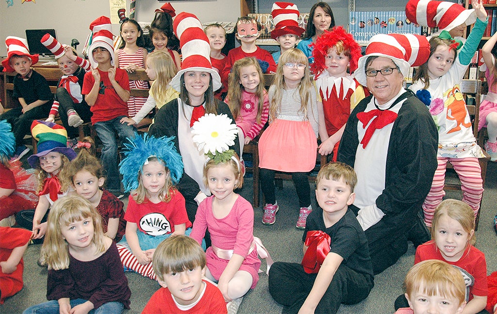 Jimmy Ramage, First National Bank board chair, and Christy Wilson, FNB employee, visited Pike Liberal Arts School Wednesday to celebrate Dr. Seuss’s birthday with the kindergarten students who came dressed as their favorite Dr. Seuss characters. Inset, Damika Rogers visited Pike County Elementary School Thursday morning dressed as Dr. Seuss’ “Cat in the Hat.” She read Seuss’s fun and silly stories to the students and laughed along with them. Rogers, who is employed at First National Bank, said she welcomed the opportunity to celebrate Dr. Seuss’ birthday with the students at PCES. 