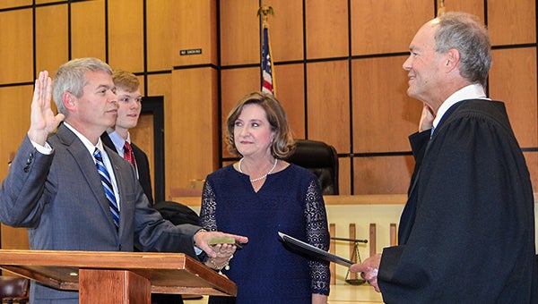 Brundidge native Ben Bowden was sworn in as the new circuit judge in Covington County on Thursday. Inset below, also at the ceremony were, from left, his parents Lawrence and Sara Bowden; Bowden; his wife Angie and Sim. 