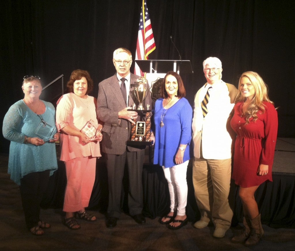 Pike County Farm-City Committee Chairman Randy Hale, center, is joined by Tammy Powell, Deborah Huggins-Davis, June Flowers, Emily Rolling and Keith Roling during the statewide awards banquet on Thursday. The Pike County group received statewide recognition for the program, the scrapbook and the tour.