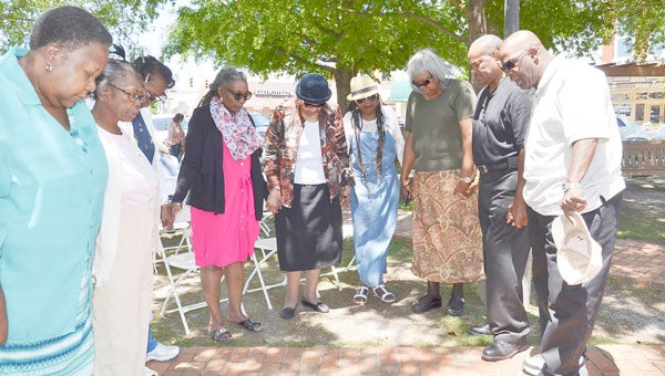 Dozens of residents joined hands as they gathered at the Square in Downtown Troy on Thursday for the National Day of Prayer events. The public ceremony culminated the week-long Bible Reading Marathon.