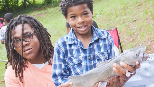There are buddies and then there are good buddies.  A good buddy takes a kid fishing. Eliza Lampley, left, is the good buddy of Isaiah Lampley. 
