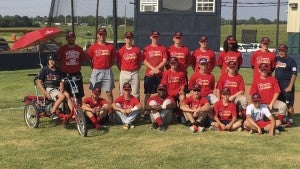 submitted  Photo XPictured is Brock Huner (back row, standing, third from the left) and the Wiregrass Cardinals 15U team after winning the Gary “Tiny” Bernath Classic in Dothan Alabama. The Cardinals are coached by legendary coach Sammy Frichter (standing, far right”
