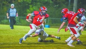 submitted Photo/jonah enfinger Pike Patriots quarterback Reed Jinright runs the ball against Lee Scott. Jinright and the Patriots fell to the Warriors 28-14.