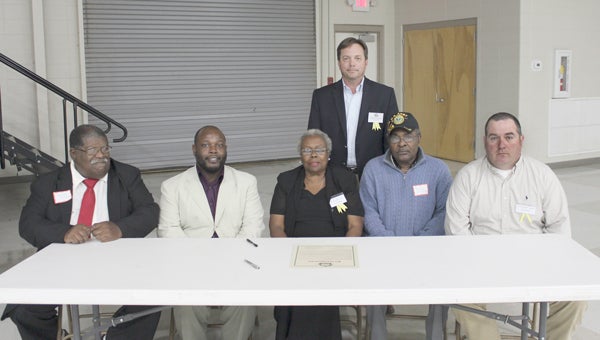 Representatives from the city and county governments in Pike County signed a proclamation at the Farm-City Banquet Wednesday night proclaiming the week of Nov. 18-14 Farm-City Week in Pike County. Pictured, standing, Troy City Council Member Marcus Paramore.  Seated from left, Brundidge Council Members Arthur Lee Griffin and Chris Foster, Brundidge Mayor Isabell Boyd, Goshen Council Member Mack Barber and Goshen Mayor Darren Jordan. Not pictured Pike County Probate Judge Wes Allen. Representatives from the Pike County Commissioners and Banks Town Council also signed the proclamation.