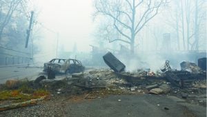 A structure and vehicle are damaged from the wildfires around Gatlinburg, Tenn., on  Tuesday, Nov. 29, 2016.  Rain had begun to fall in some areas, but experts predicted it would not be enough to end the relentless drought that has spread across several Southern states and provided fuel for fires now burning for weeks in states including Tennessee, Georgia and North Carolina. (Michael Patrick/Knoxville News Sentinel via AP)